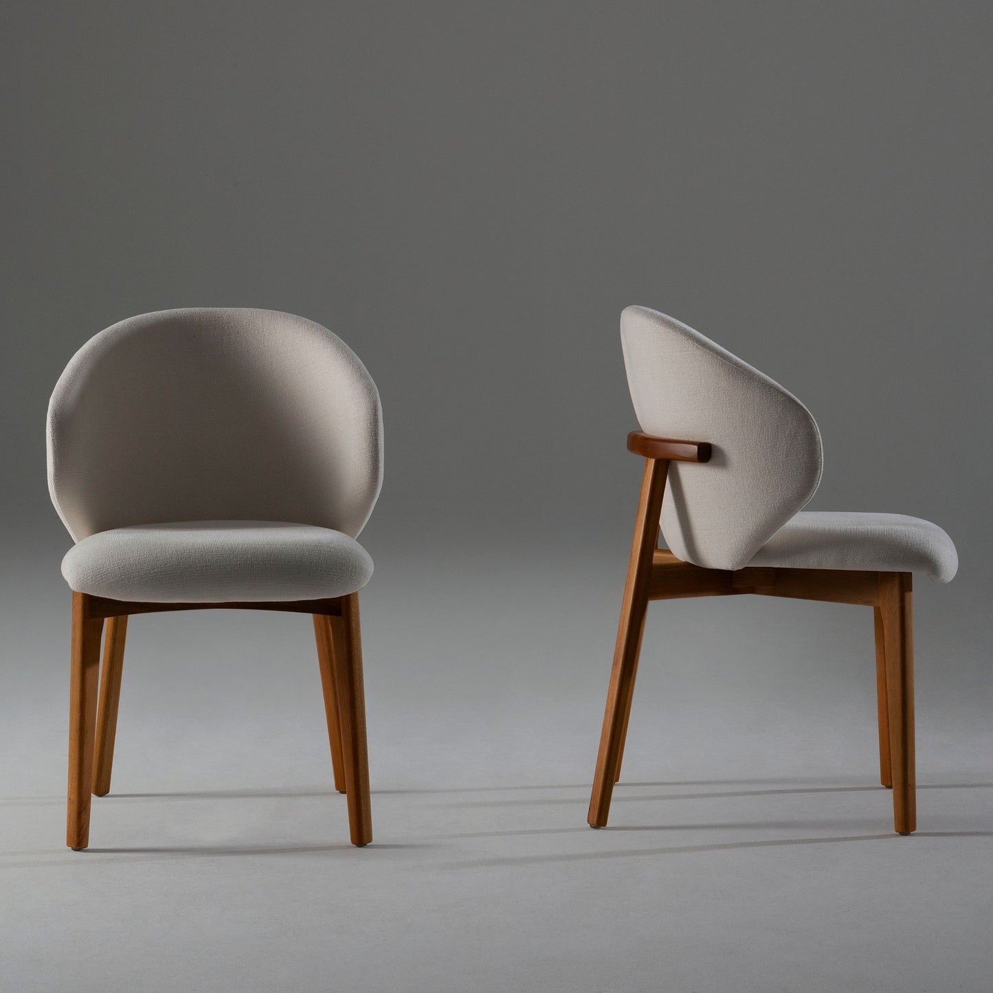 Modern Kayra Dining Chair in beige linen with curved backrest and natural wood legs.