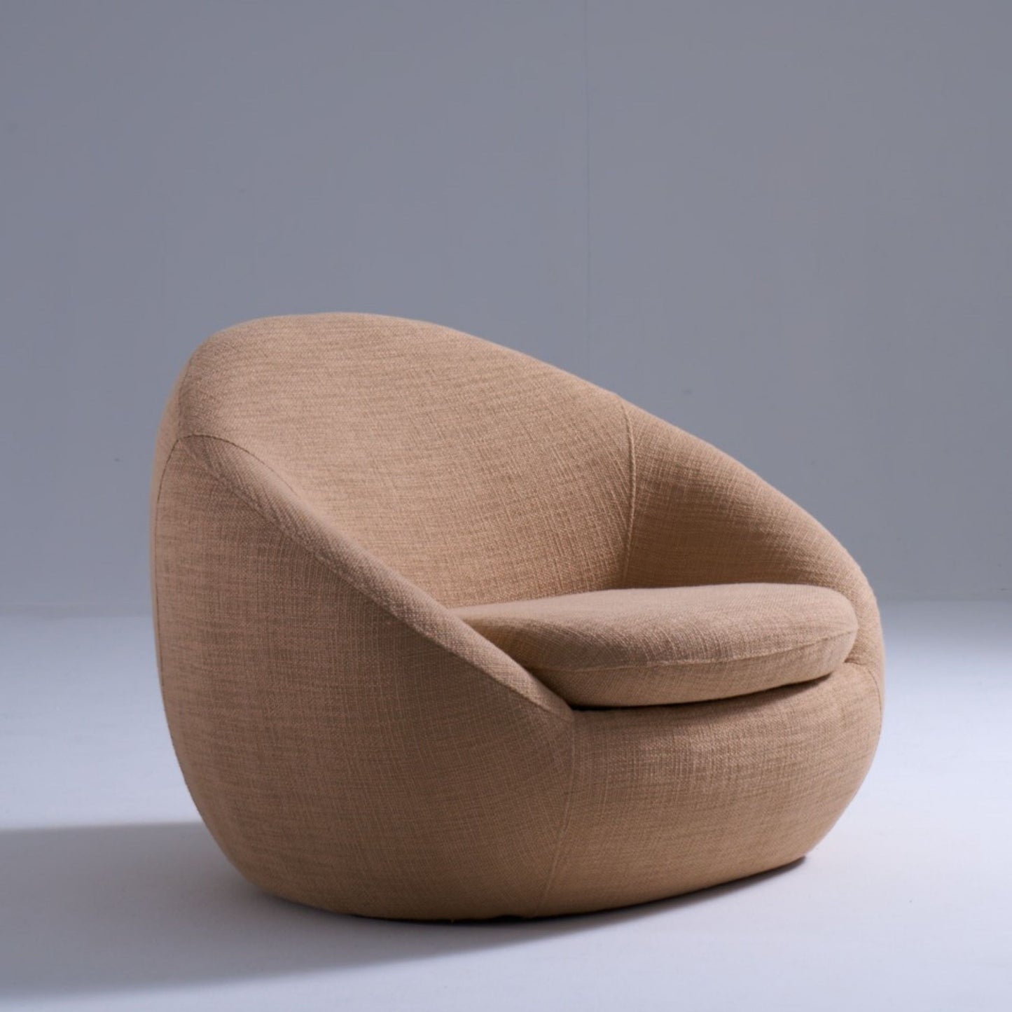 Cream accent chair in plush teddy fabric with soft curved silhouette
